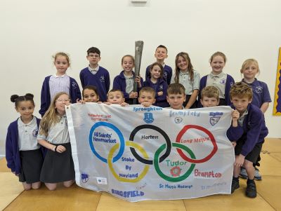 Mellis children with torch and Olympic flag