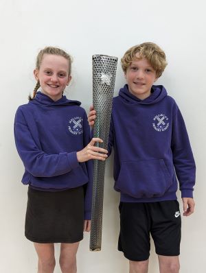 Mellis sports captains with torch